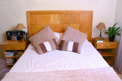 This modern headboard and bed pedestals are made of solid red oak. The headboard consists of square wooden blocks