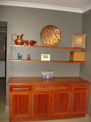 Built-in sideboard made of rosewood with solid top and floating shelves