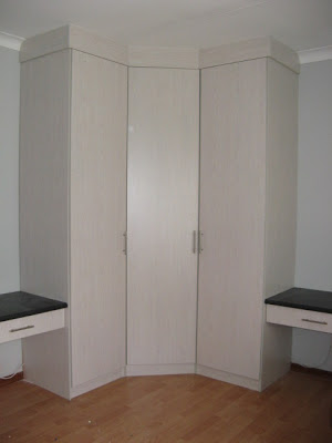 Corner-cupboard made of black cherry (melamine) with two desks for children's room.