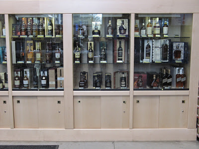Three of the five sections of a 4.7 meter wide liquor cabinet made of beech-wood (Makro Wonderboom)