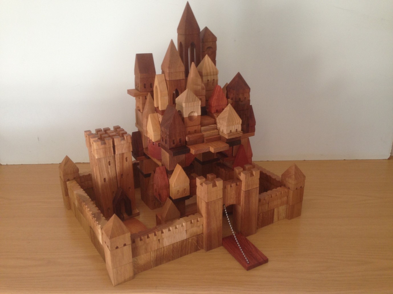 Walled Medieval city with drawbridge. Wooden blocks are made of hard and precious woods. Blocks for city: 130 pieces. Wall with drawbridge: 75 pieces